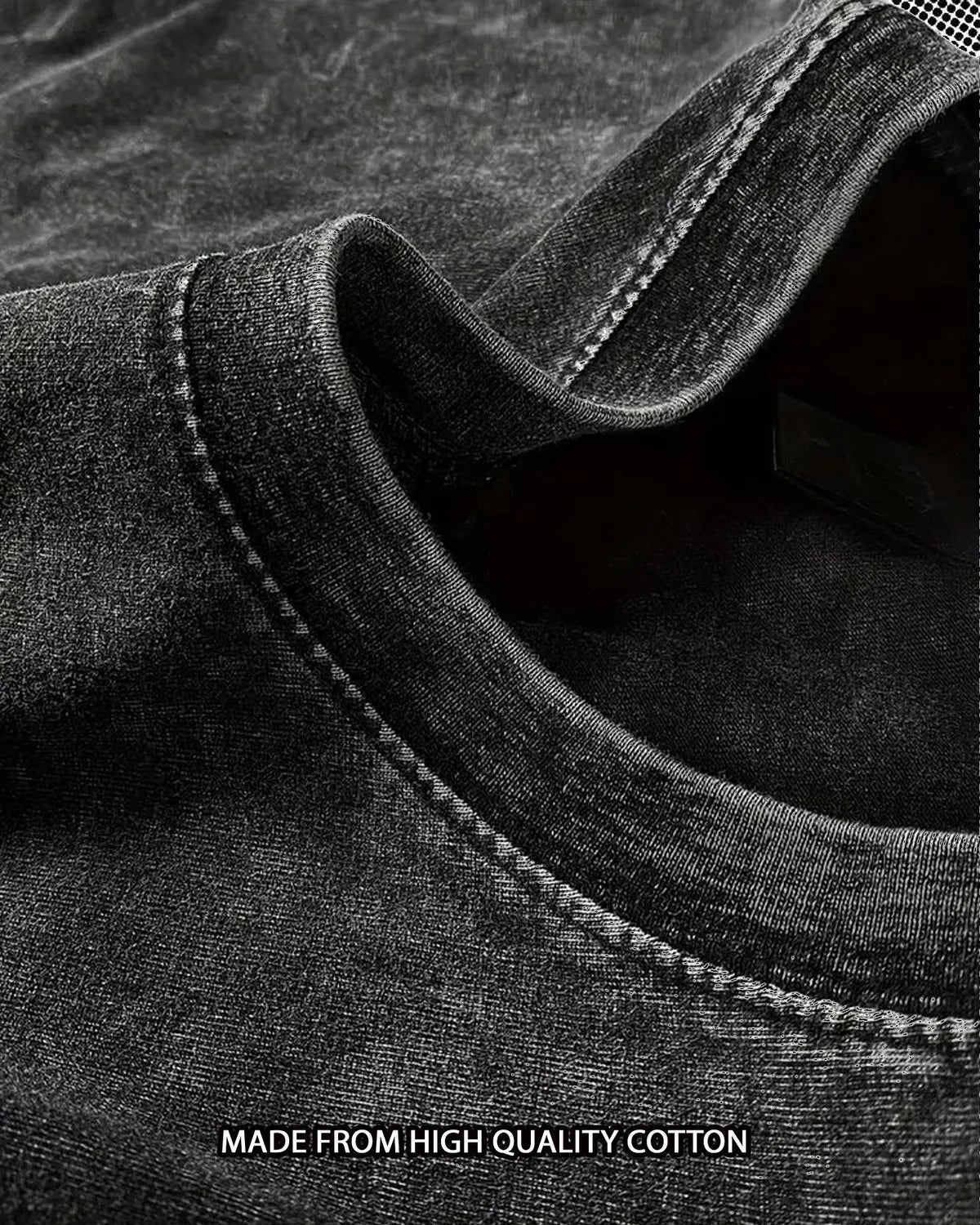 Close-up of acid wash oversized tshirt fabric with stitching detail, labeled 'Made from high quality cotton'.