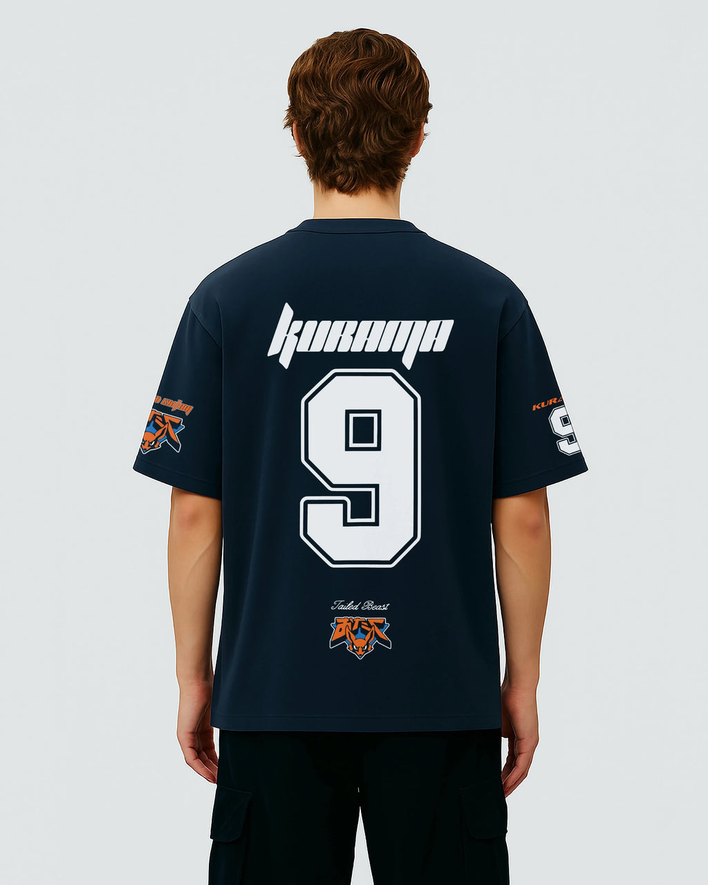 Person wearing a navy blue oversized jersey with white text, numbers and design from naruto on a plain background