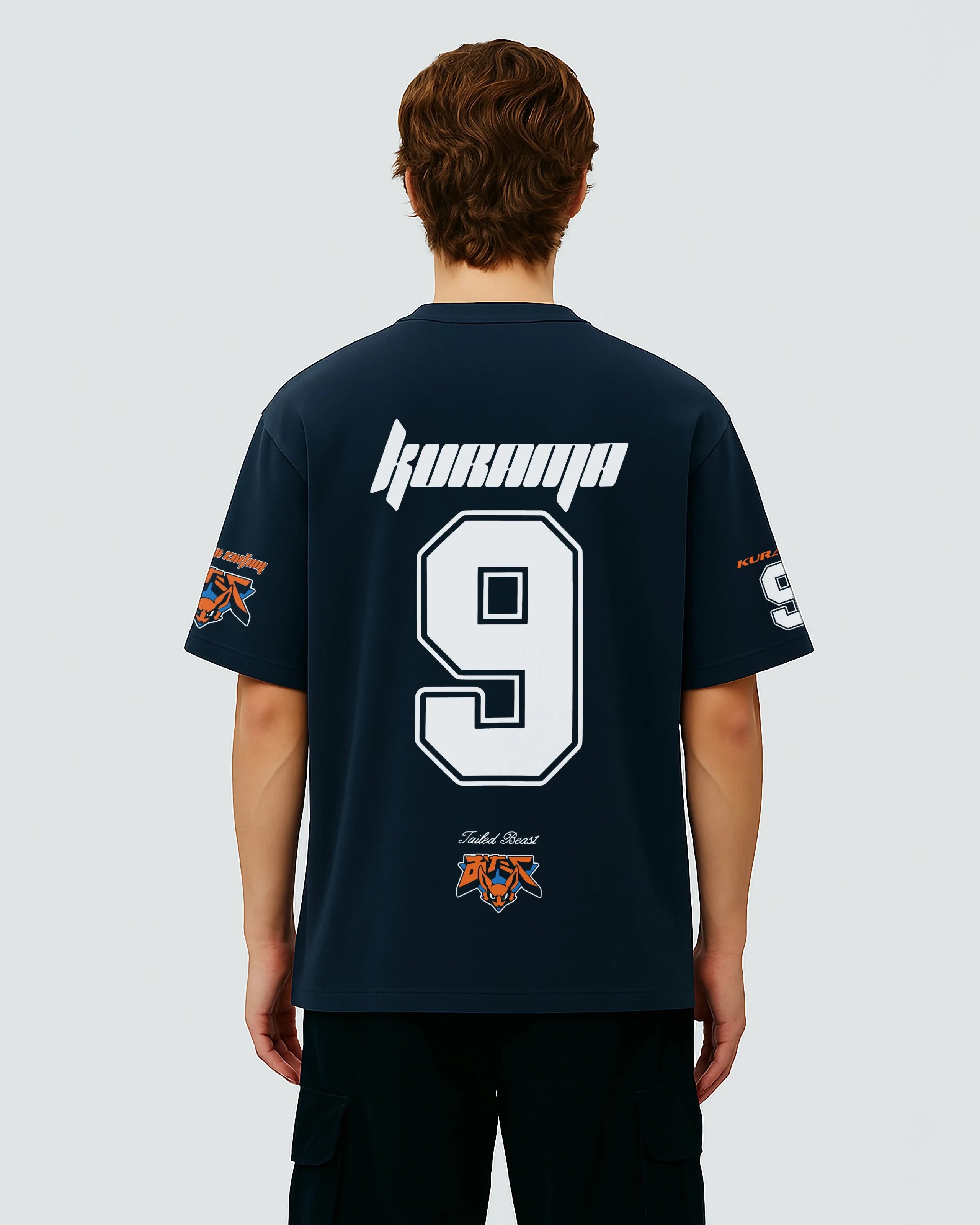 Person wearing a navy blue oversized jersey with white text, numbers and design from naruto on a plain background